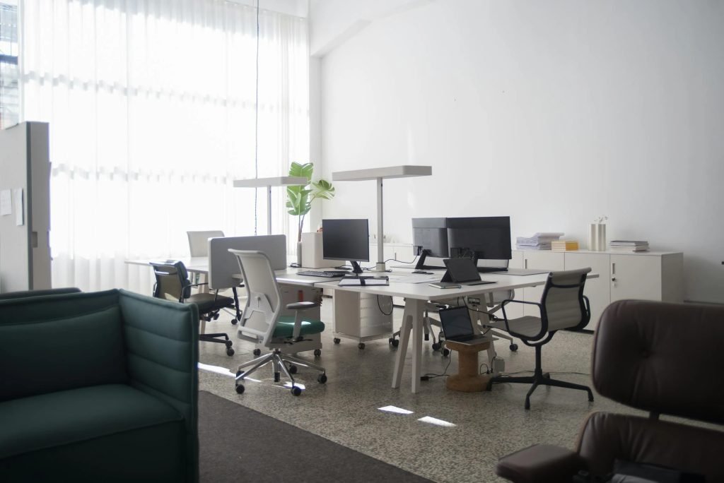 Modular office workstations with ergonomic chairs and adjustable desks.