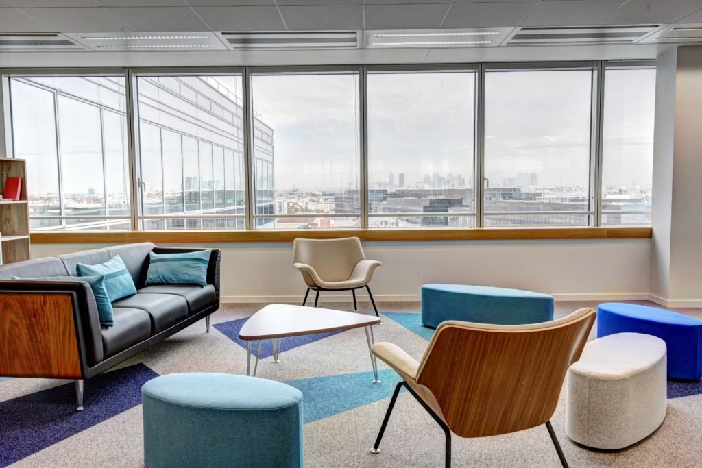 Colorful collaborative seating area with modern chairs and tables.