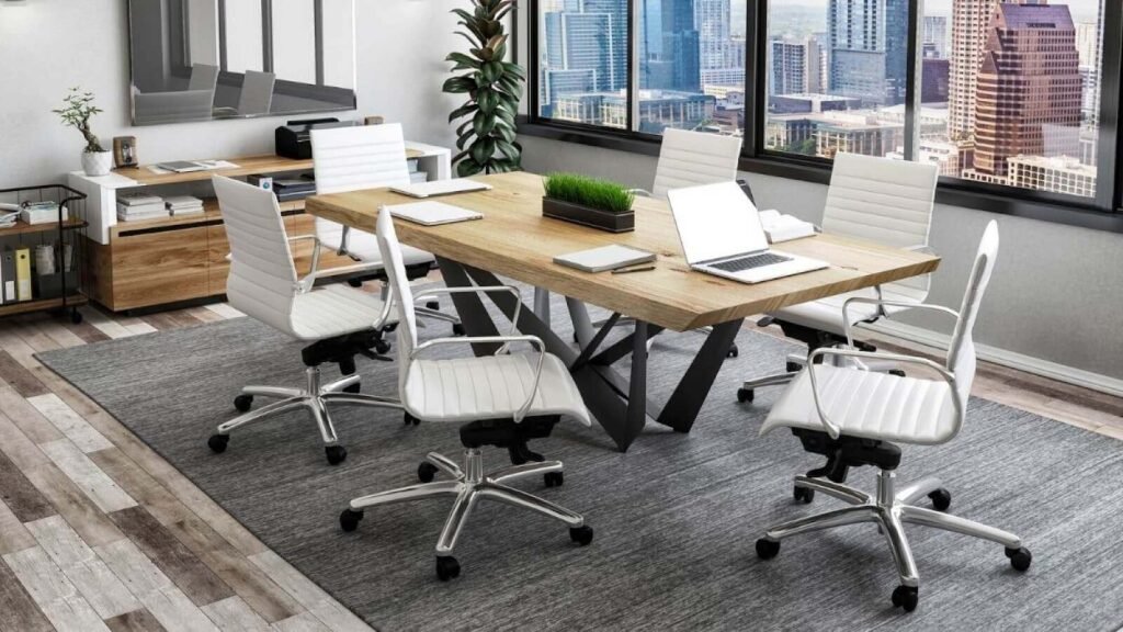  Modern conference room with a wooden table, white ergonomic office chairs, and a backdrop of cityscape through large windows.